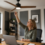 A woman adjusting the speed of a ceiling fan in her home office studio with acoustic panels.